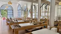 Sala luminosa con equipos de Pilates Reformer.